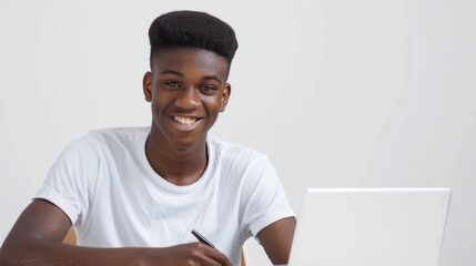 Smiling African American Teen Boy Using Laptop for Studying at Home