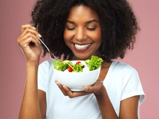 Smile, eating and woman with salad for wellness, fresh and detox lunch meal with vegetables. Happy,...