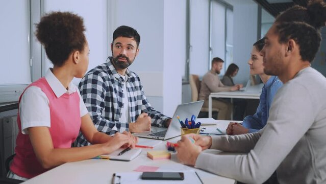 Team members collaborate and exchange handshakes during office meeting, fostering teamwork and mutual respect in professional environment