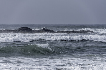 Waves Crashing on Rocky Shore at Amoreira Beach, Portugal
