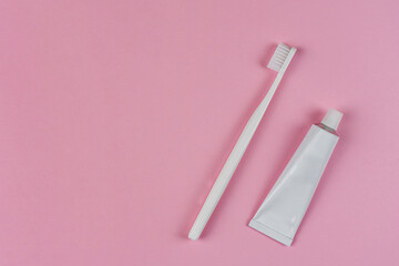 Toothpaste and toothbrush on a pink background. The concept of dentistry, health, health care, oral care. Oral hygiene, professional teeth cleaning for a dental clinic, copyspace for text