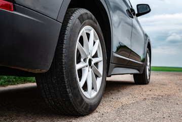Close-up of black car at crossroads.