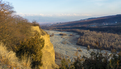 Stone bed of the Turdo River between the mountains. Snow-capped Caucasus ridge, Telavi city