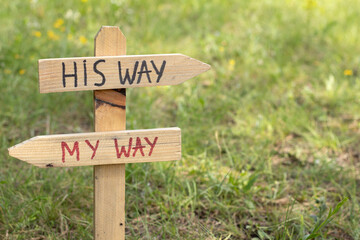 God Jesus Christ's way of life, handwritten text on wooden sign in nature. Christian path, journey,...