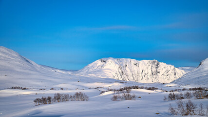 Norwegian high mountains in the snow. Mountains covered with snow. Scandinavia