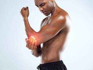 Man, elbow and injury with fitness in studio, red glow or training by white background. African...