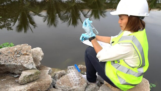 Environmental engineers and scientists inspecting water quality before treatment for potable use,checking water pollution,testing contaminants,collecting water samples for lab analysis to ensure safe