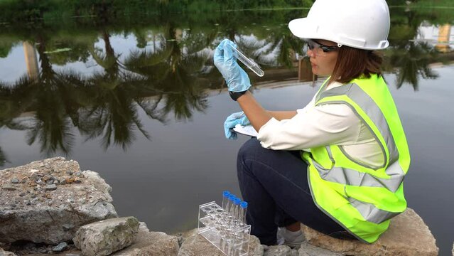 Environmental engineers and scientists inspecting water quality before treatment for potable use,checking water pollution,testing contaminants,collecting water samples for lab analysis to ensure safe