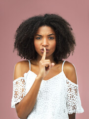 Hush, portrait and serious with afro black woman in studio on pink background for secret, silent or...