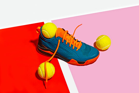 Padle sport shoe and yellow balls over colorful background