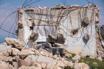 Ruined building. A pile of concrete, rubble and reinforcement debris in middle of urban place...