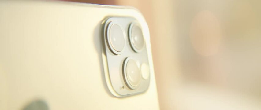 View on macro shot with tilt-shift lens on the triple-lens camera on smartphone. Colourful light. Moving around