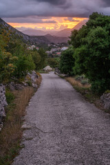 A scenic road in Dalmatia with a view of the sunrise over the Biokovo mountain massif