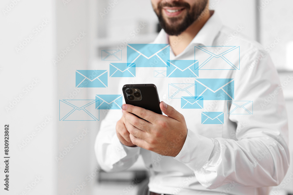 Poster smiling man with smartphone chatting indoors, closeup. many illustrations of envelope as incoming me