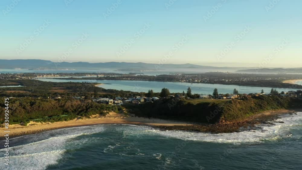 Wall mural Aerial panning along Pacific coast of Caves beach town in NSW of Australia.
