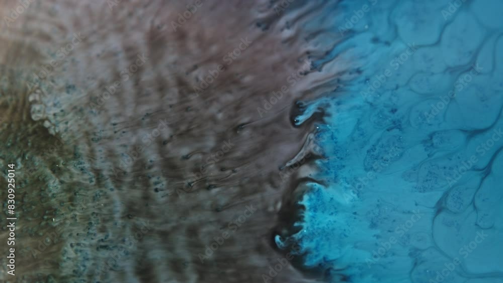 Poster blue ink merging with brown ink in water creates mesmerizing abstract patterns