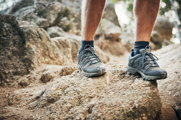 Legs, rocks and hiking shoes outdoors for fitness with health in mountain nature for exploration....