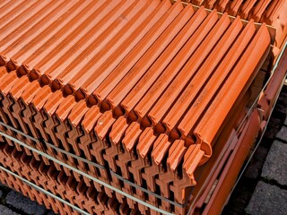 Interlock tiles for roofing stacked on a pallet 