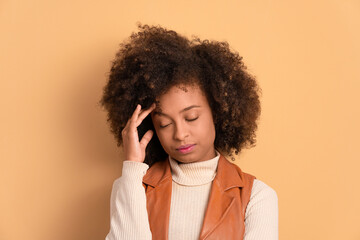 puzzled afro brazilian woman with hands over the face in beige background. frustration, unhappy, problem concept.