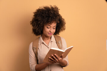 focused college student studying with book in studio shot. learn, school, student life concept.