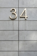 metal number thirty-four in a facade  divided into rectangles in horizontally