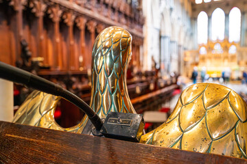 Shallow focus of a gold metal bird forming part of a lectern in a famous English cathedral. The on...