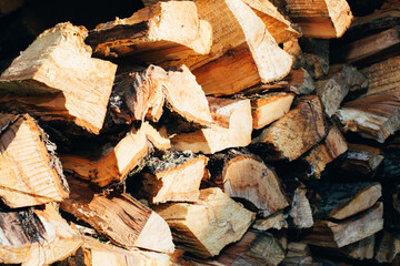 Natural wooden textured background. Folded different bars of firewood. Side view