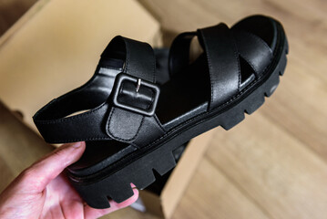 Unpacking box of new women's sandals.