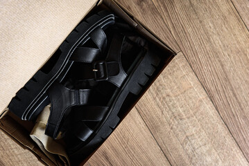Unpacking box of new women's sandals.