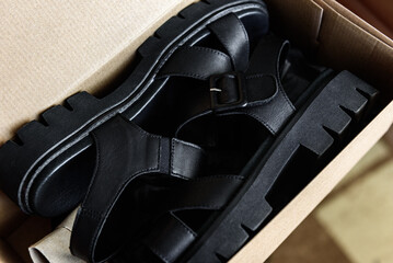 Unpacking box of new women's sandals.