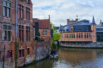 Naklejka premium Scenic view of the historical city center of Ghent (Gent), Belgium. Beautiful cityscape with medieval architecture, monumental landmarks and Lys river with tourist boats, outdoor travel background