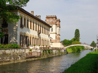 Fototapeta premium Historic buildings along the cycleway of Naviglio Grande, Milan, Italy, at Robecco