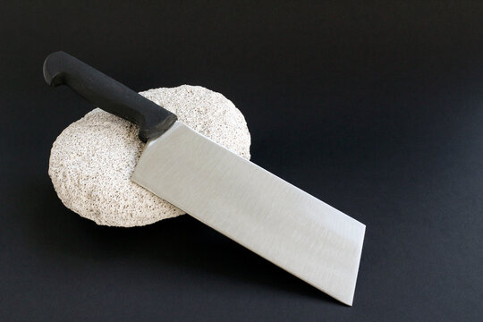 Unused,new, sharp butcher knife on black surface with copy space