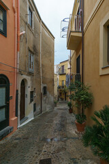 Narrow street in the old town of Cefalu on a cloudy rainy day, Cefalu, Sicily, Italy