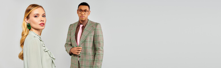 A man and woman stand together in a loving pose.