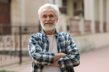 Portrait of happy grandpa with grey hair outdoors