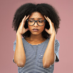 Stress, headache and woman with glasses in studio overwhelmed by blurred vision, vertigo or crisis on pink background. Anxiety, fail and girl model frustrated, sad or overthinking, mistake or trauma