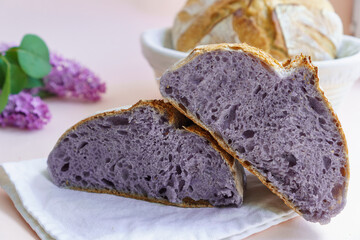 Homemade Artisan Purple Bread Sourdough Made from Purple Sweet Potato. with natural color. Purple tartine cut into slices.