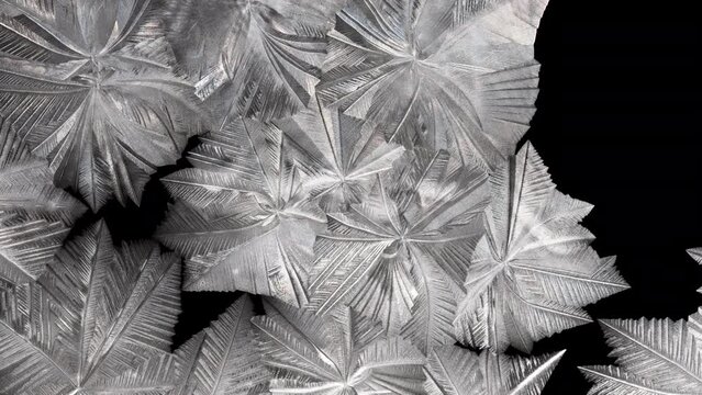 White crystal pattern forming from a freezing soap bubble. Macro abstract background. 