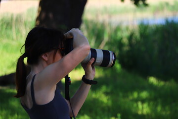 a photographer woman in action with camera