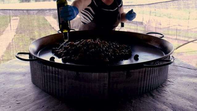 cook a lot of snails in a frying pan. Selective focus.