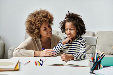A joyful African American mother assists her daughter with homework, fostering a strong bond...