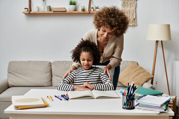 Happy African American mother and daughter study together at home, focusing on homework.