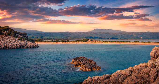 Sunset on rocky coast of Voidokilia Beach. Impressive summer seascpae of Ionian sea, Pilos town location, Peloponnese peninsula, Greece, Europe. Vacation concept background.