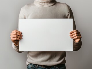 Man holding a blank white canvas mockup against a wall - Powered by Adobe