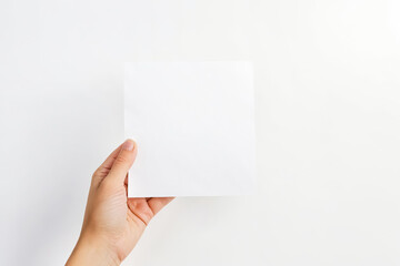 Fototapeta premium Hand Holding Blank White Paper On White Background