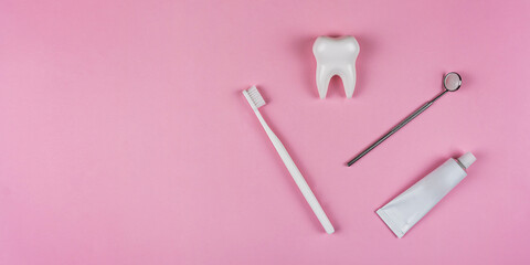 Healthy white tooth, toothpaste and toothbrush on a pink background. The concept of dentistry, health, health care, oral care. Oral hygiene, professional teeth cleaning for a dental clinic, copyspace 
