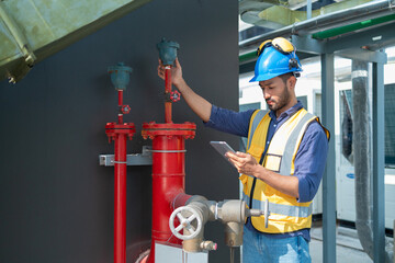 Engineer under industrial inspection Large water heaters are used in high-rise condominiums.