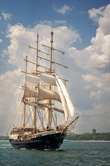 Old ship with white sales, sailing in the sea