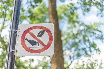 A do not feed the birds sign.
